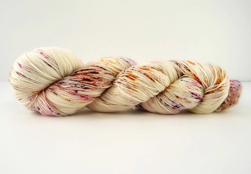 Multicolored skein of yarn on a white background