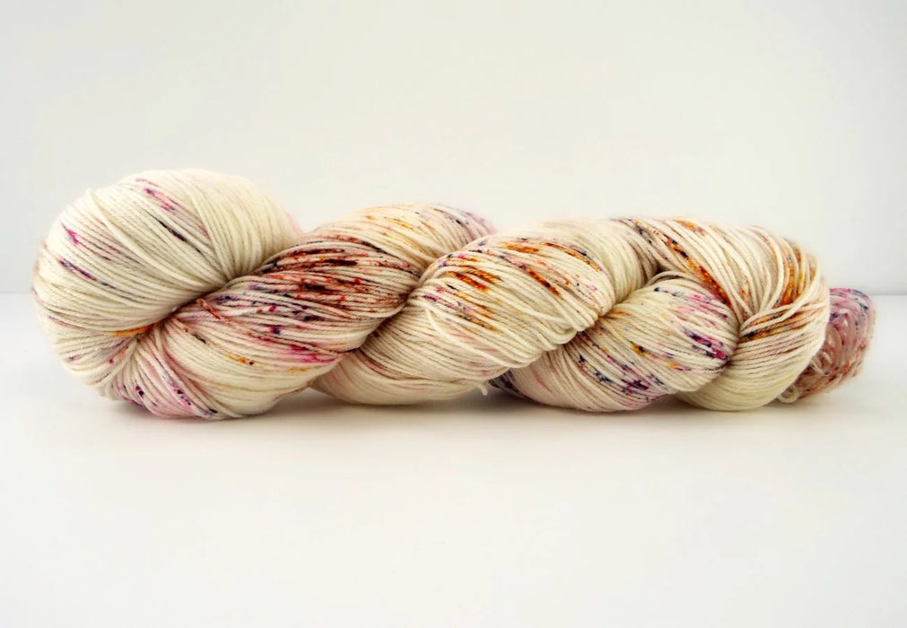 Multicolored skein of yarn on a white background
