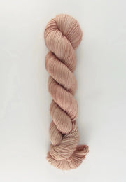 Ball of pink yarn on a white background