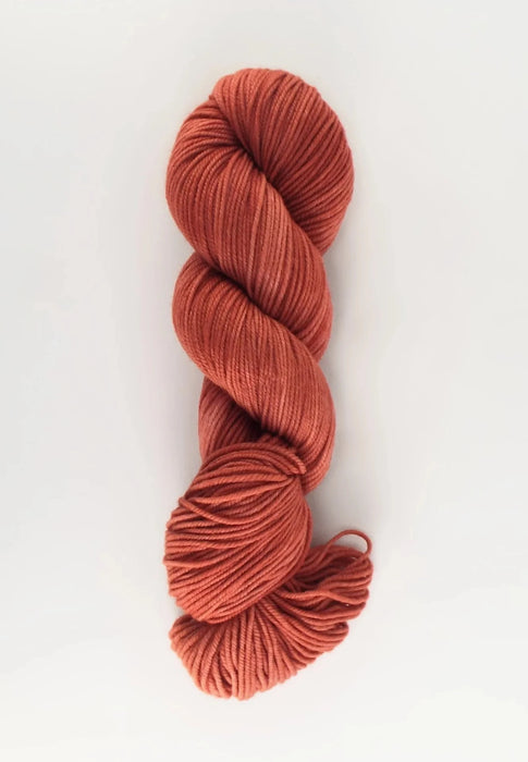 Red skein of yarn on a white background