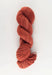 Red skein of yarn on a white background
