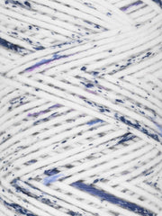 Close-up of speckled yarn with white, blue, and purple colors.