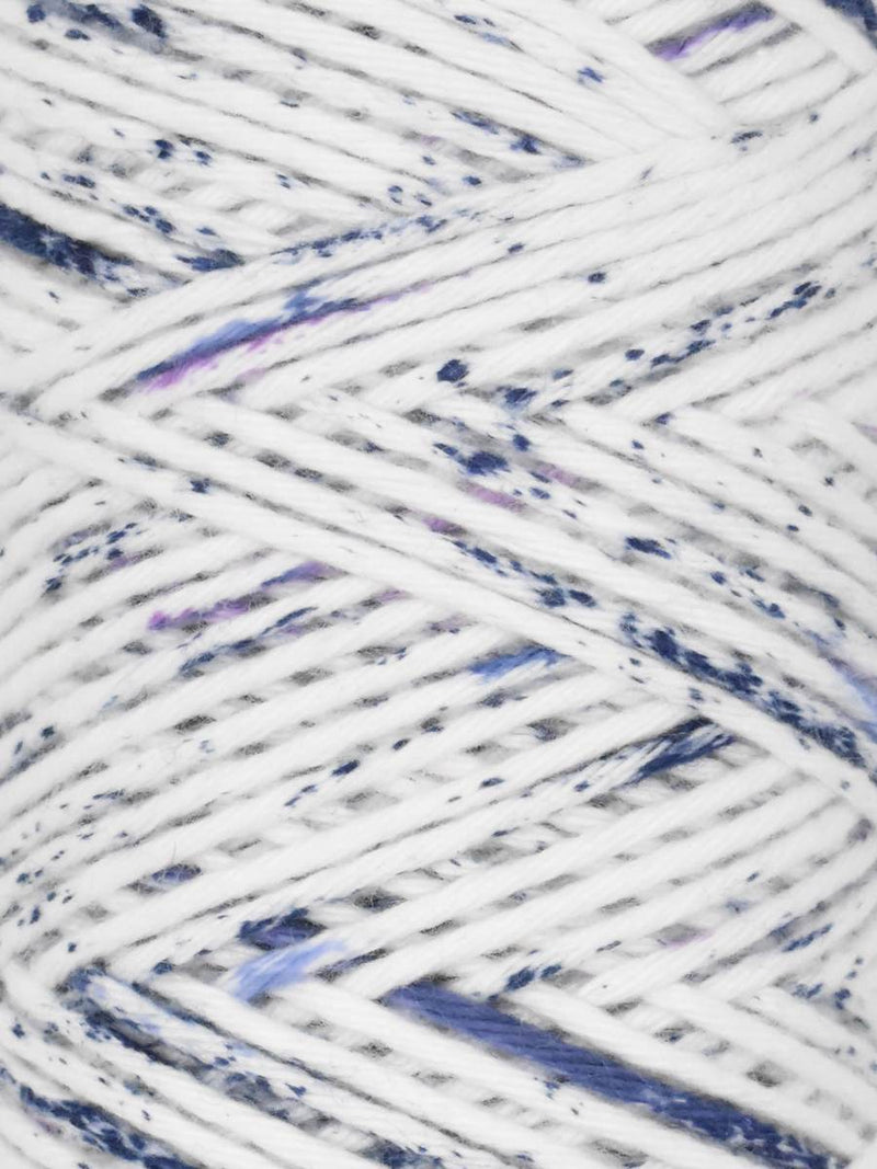 Close-up of speckled yarn with white, blue, and purple colors.