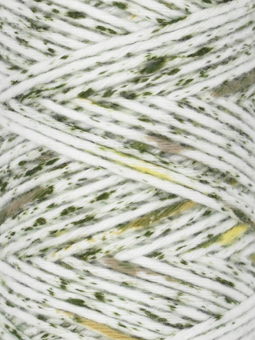 Close-up of white yarn with green and brown speckles