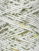 Close-up of white yarn with green and brown speckles