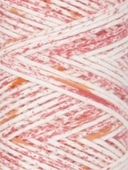 Close-up of multicolored yarn with pink, orange, and white hues.