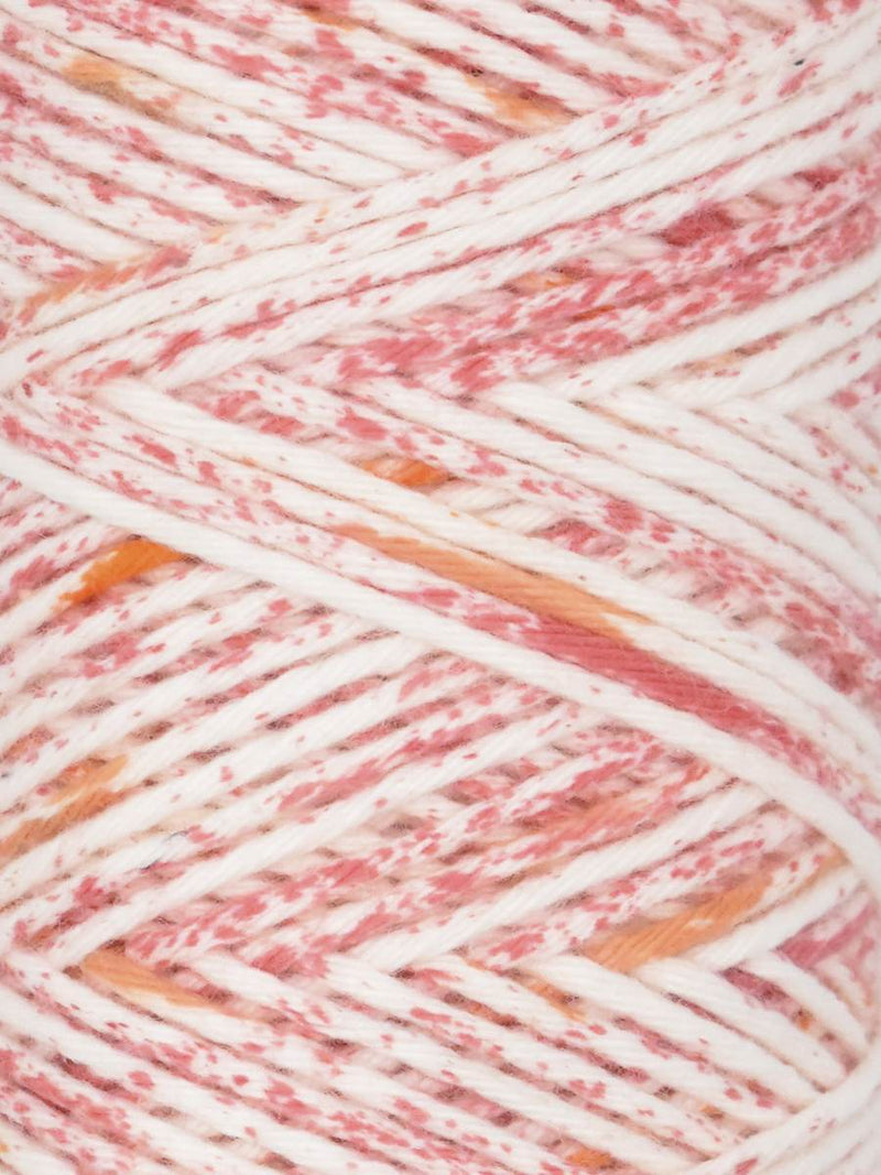 Close-up of multicolored yarn with pink, orange, and white hues.