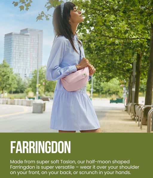 Woman holding a pink handbag with Farringdon branding in an urban setting.