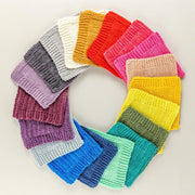 Circular arrangement of colorful knitted swatches on a light background