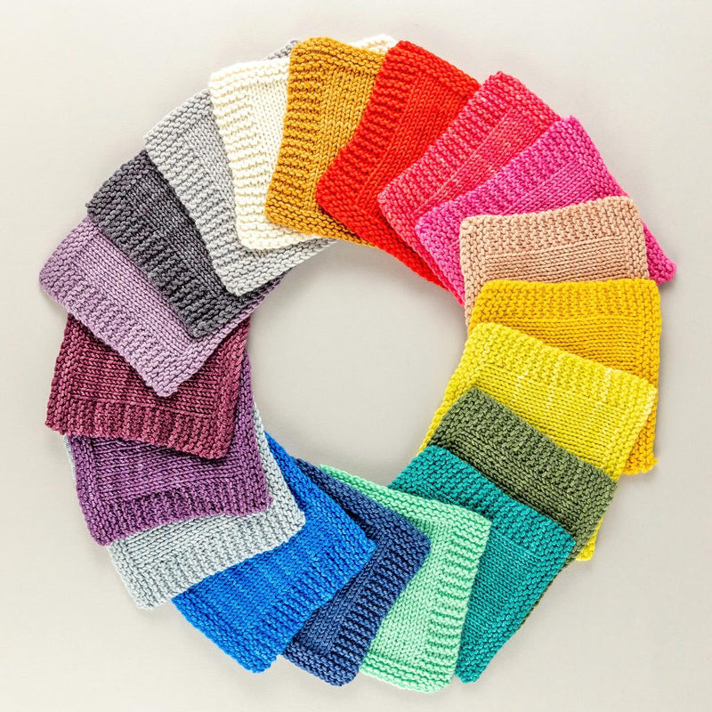 Circular arrangement of colorful knitted swatches on a light background