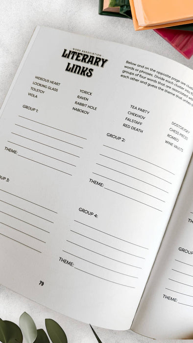 Open book with a page titled 'Literary Links' on a white surface with green leaves.