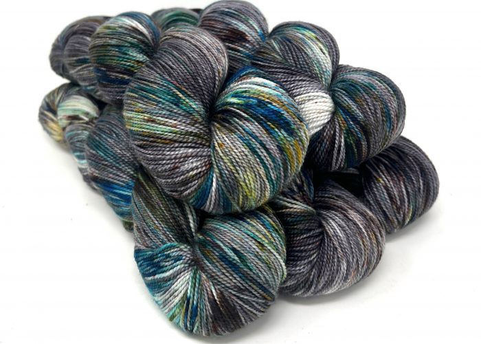 Multicolored skeins of yarn on a white background