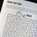 Maze labeled 'Phone Tree Trap' with text instructions on a printed page.