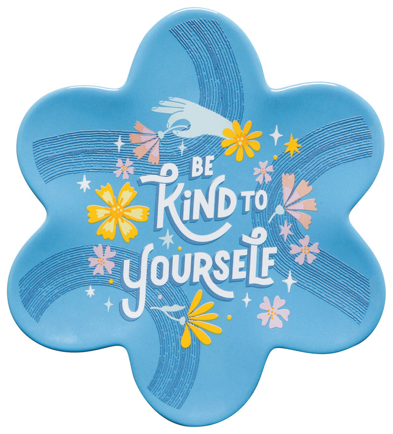 Blue flower-shaped dish with 'Be Kind to Yourself' text and floral designs on a white background