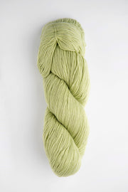 Braided skein of green yarn on a white background
