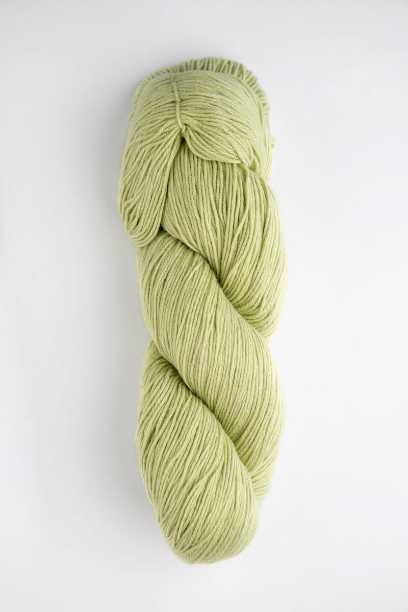 Braided skein of green yarn on a white background