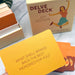 Delve Deck Joy Edition card game with a yellow card and packaging on a light background