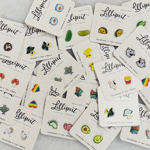 Collection of 'Lilliput Little Things' pins on display cards.