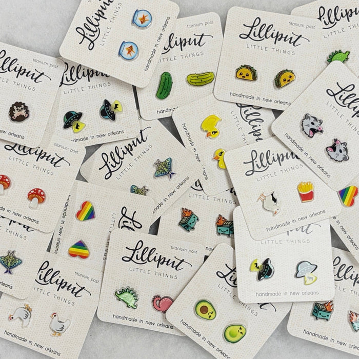 Collection of 'Lilliput Little Things' pins on display cards.