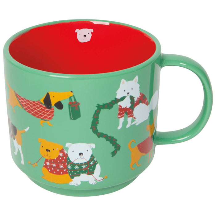 Green mug with dog pattern and red interior on a white background