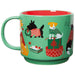 Green mug with festive dog illustrations on a white background