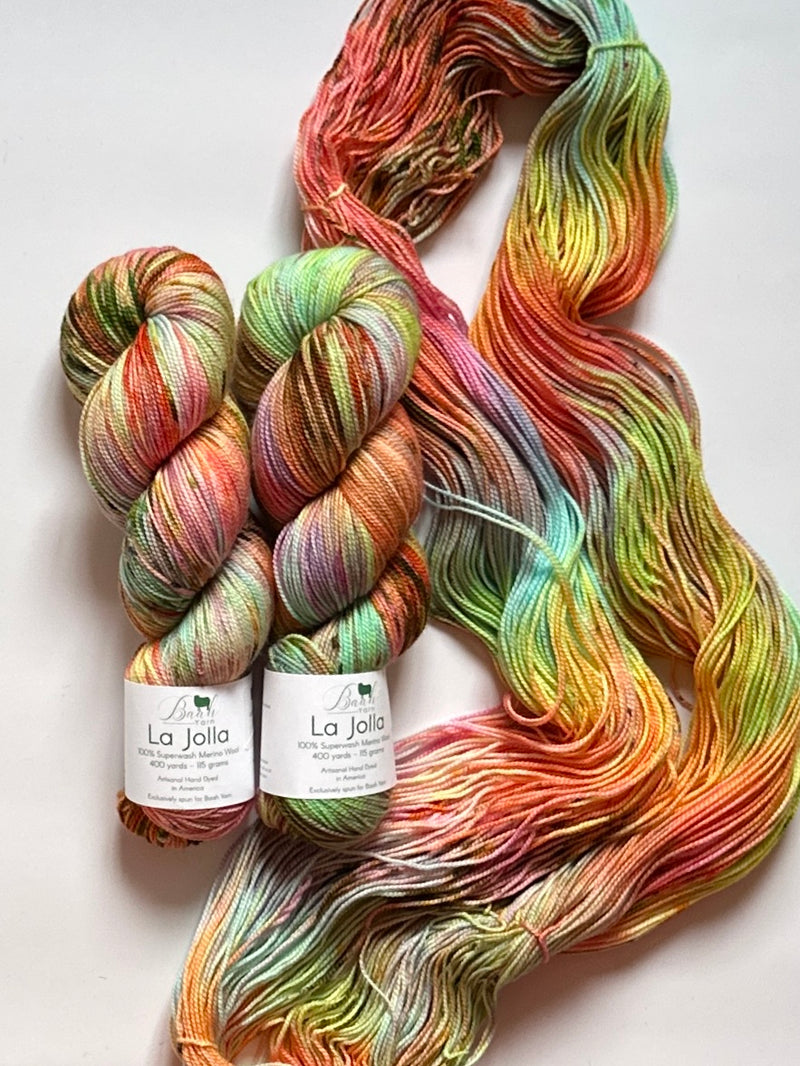 Two skeins of multicolored yarn with 'La Jolla' labels on a white background