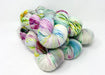 Multicolored skeins of yarn on a white background