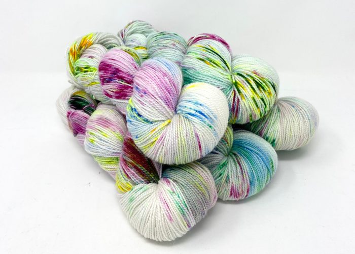 Multicolored skeins of yarn on a white background