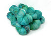Turquoise skeins of yarn on a white background