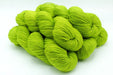Bunch of bright green yarn on a white background