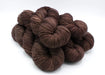 Brown yarn skeins on a white background