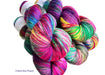 Colorful skeins of yarn with the words "Crave the Chaos" on a white background