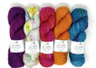 A collection of hand-dyed fingering weight yarn skeins in various colors, labeled 'La Jolla' by Baah Yarn.