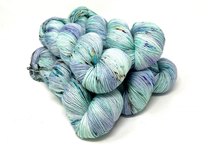 Multicolored skeins of yarn on a white background