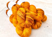 Bunch of orange yarn on a light background
