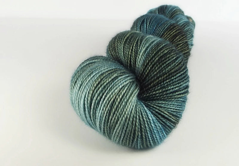 Skein of blue yarn on a white background