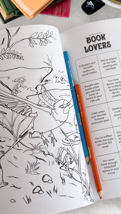 Coloring book with a bird illustration and a pencil on a table.