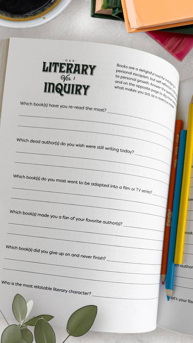 Open book with a questionnaire titled 'Literary Inquiry' on a table with pencils and a plant.