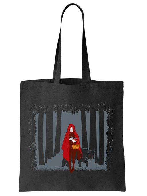 Black tote bag with a graphic of a Red Riding Hood in a forest and a wolf.