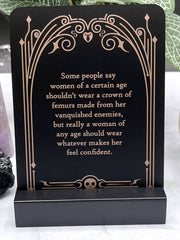 Decorative plaque with a motivational quote on a black background