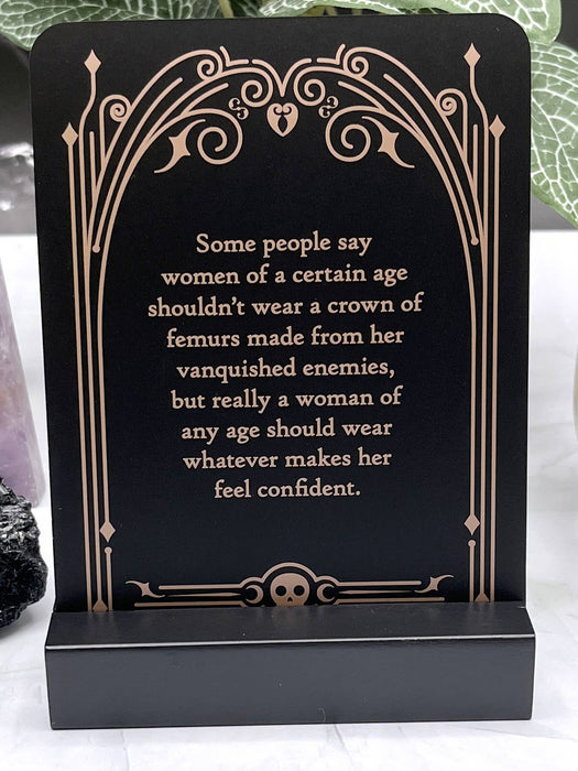 Decorative plaque with a motivational quote on a black background