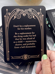 Card with a humorous message held by a hand, surrounded by other cards.