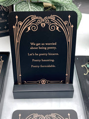 Decorative card with a quote on a black stand