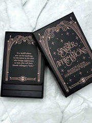 Black card deck with decorative text on a marble surface