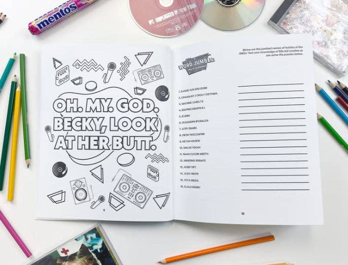 Open book with humorous text and illustrations on a table with stationery items.